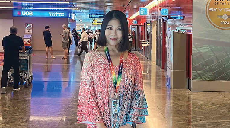 Singapore airport manager in the terminal, smiling at camera