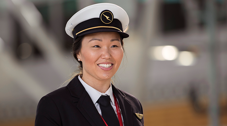 flight crew smiling as they leave the terminal