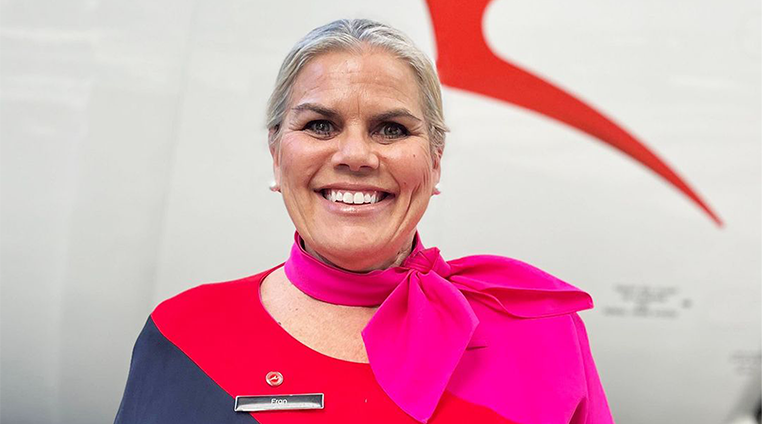 A First Nations cabin crew member, smiling at camera