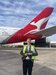 Jack in front of a Qantas Tail on tarmac in high vis